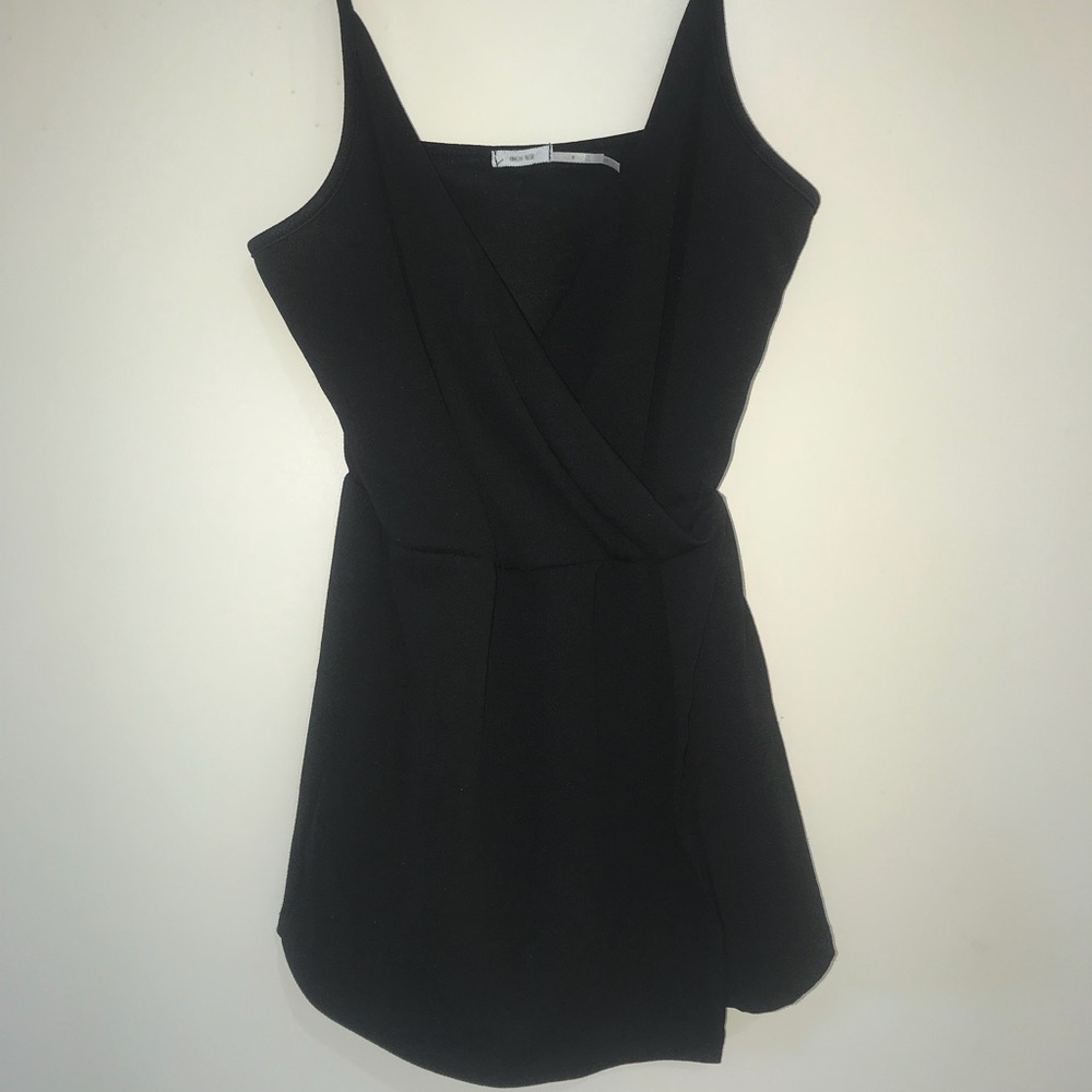 Black romper with asymmetric front flap and deep v